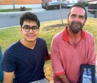 VideoMed cofounder Farhan Ahmad is pictured with Max, a homeless man in San Antonio.