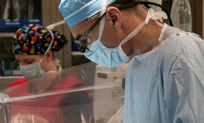 photo of a surgeon in an operating room, cropped to his head