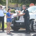Officers from the UT Tyler PD gathered with other local law enforcement at Broadway Square Mall in Tyler, where they were greeted by a UT Tyler student with flowers and a thank you note.