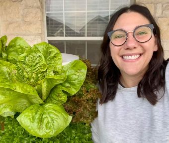 Jen Zaligson in front of her very impressively large lettuce head