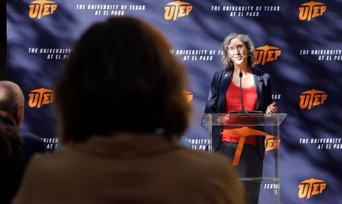 Anne-Marie Núñez, Ph.D. standing at a podium in front of UT El Paso banner speaking to an audience