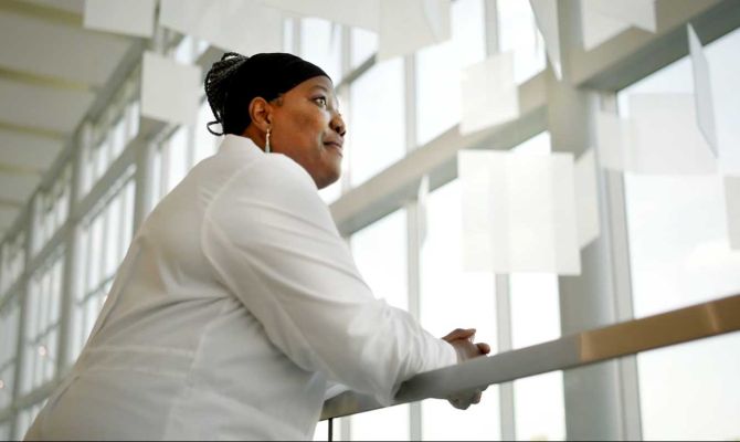 Fiona Strasserking, M.D. looking aspirationally over a loft railing