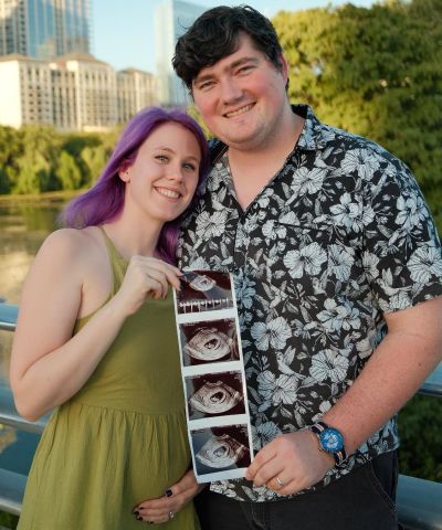 Caleb Perkins, UT System's Manager of Information Systems, Client Services, with his wife, Megan, holding a photograph of their sonogram. The couple is expecting a baby girl in March.