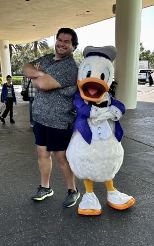 Enrique Jasso, TMDSAS Director and TXHES Communications and Outreach Strategist, poses with Donald Duck
